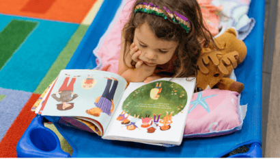 Teacher reviewing a child's work at a Christian preschool in Roanoke TX
